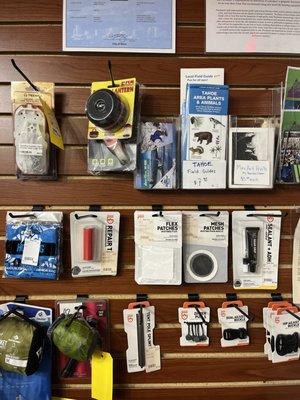 Guides, maps, and gear repair equipment is sold at Gear Hut! Come check out our wall of small items-located to the right of the front door!