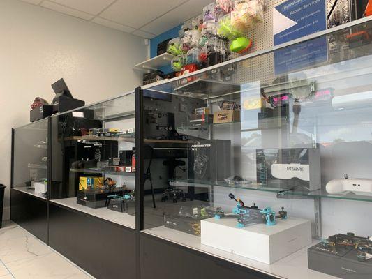 Storefront product display cases with drones and electronics parts