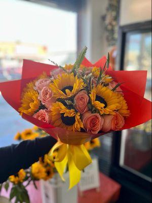Mix of sunflowers and orange roses.