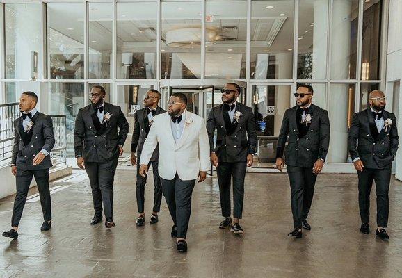 Groom in his wedding suit alongside his groomsmen in their custom AfroVine clothing.