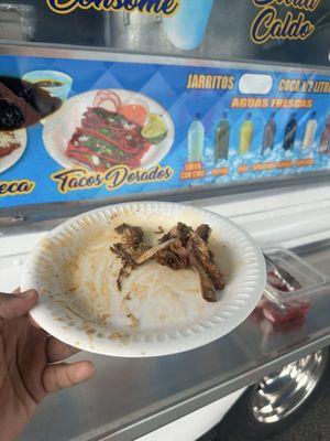 A finished plate of Birria de Chivo with rice and beans