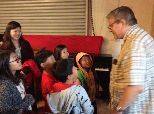 Piano Technician and Restorer John teaches the next generation of pianists from the "Piano Mom" group.