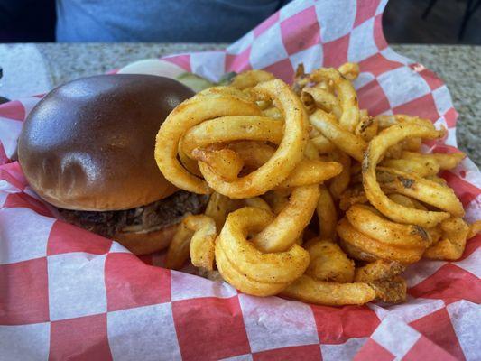 Brisket sandwich with curly fries.