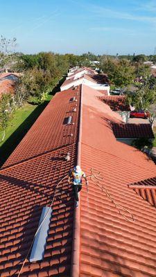 Sandbar Soft washing the tile roofs in Mainlands Las Villas Pinellas Park.