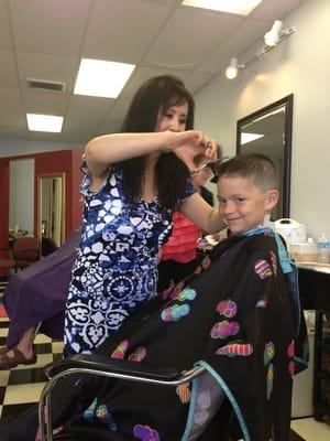 My son getting his hair cut by Susie.