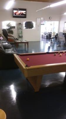Inside the barber shop, tv's, pool table, spa area, lounge area.