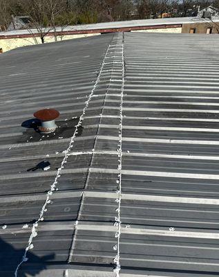 Quality repaired peak of metal roof with silicone caulking