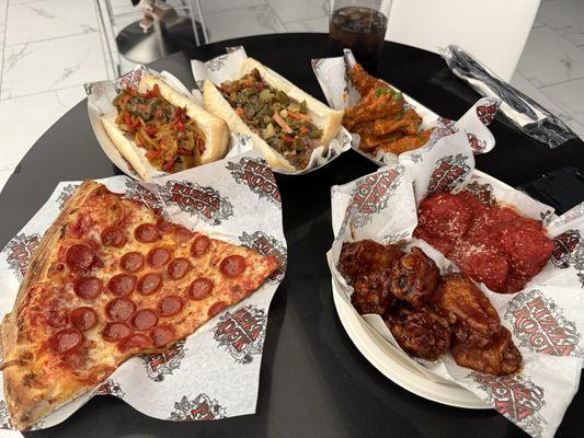New York style pizza slice, sausage sandwich, Chicago Italian beef, wings, and meatballs