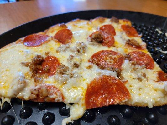 White pizza with pepperoni and sausage.