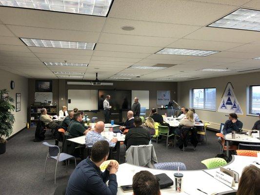 Business owners and leaders engaged in group workshop at Wilcox & Associates, LLC - Sandler Training Indiana.