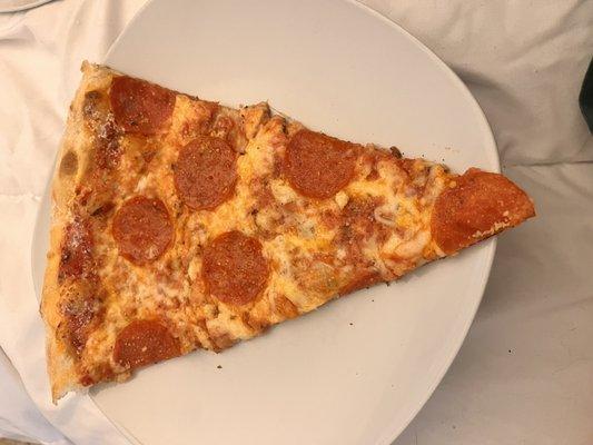Slice of thin crust pepperoni.