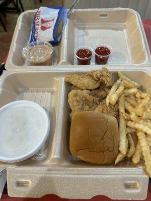 Chicken tender dinner with fries, country gravy, dipping sauce and an oatmeal cookie.