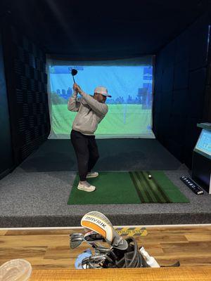 My friend in one of the simulator bays. Each bay has a bar table with a few stools.