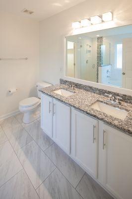 After renovations. What a great improvement including marbleized tile floors instead of linoleum and granite countertop instead of laminate.