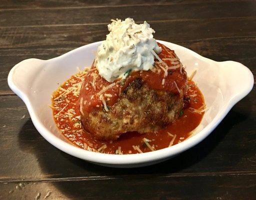 The Fireside Meatball;  A one pound house made meatball with housemate marinara, topped with whipped ricotta.