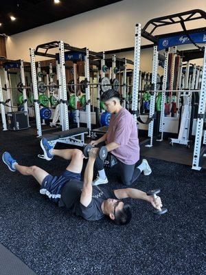 Team Athlete Julian showing one of our clients steps on repairing lower back!