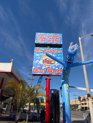 Mr. Bubbles 100% Hand Car Wash entrance sign, street view, inflatable air dancer.