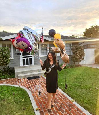 Holding my balloon arrangements.