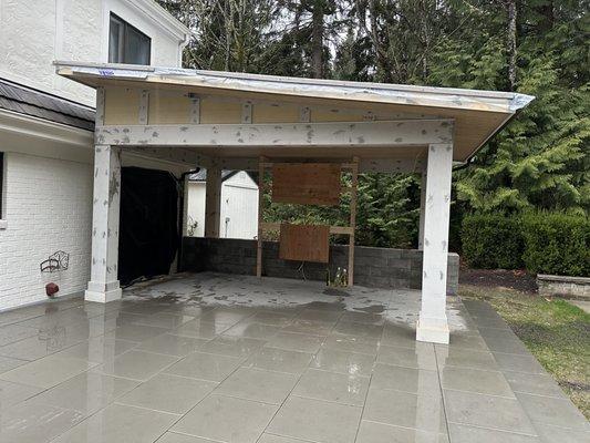 Custom covered patio with tile floor, strong roof, and sleek design--perfect for outdoor living. Contact us to build yours today!