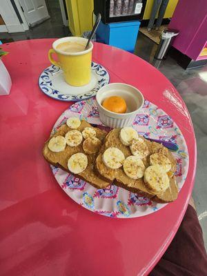 The Sweet: Grain toast with peanut butter spread, banana slices, honey drizzle and cinnamon powder with an orange. Cafe on leche to drink.