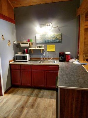 Kitchenette fully stocked with plates, silverware, pots and pans, Toaster, Microwave, Coffeemaker, electric double burner, mi...