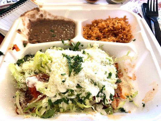 Red Tres Chicken enchiladas with rice and beans.