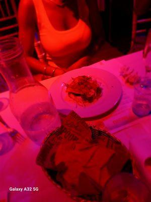 The guacamole, chips, and one of the small plates of food.