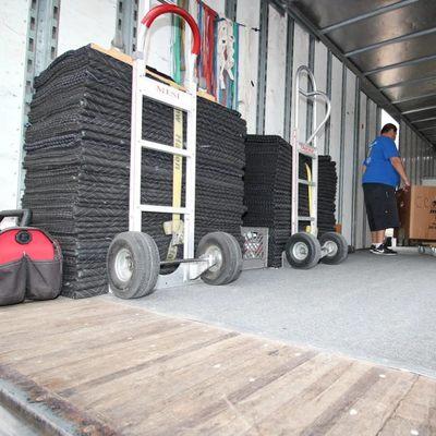 Moving blankets, dollies, and equipment loaded into an Econo Move & Storage truck for professional residential or commercial ...