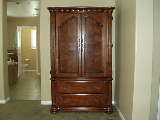 The armoire came in two very heavy pieces: about 200lb each they told me. they secured them together with two brackets.