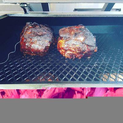A few pork butts smoking low and slow getting that bark to perfection