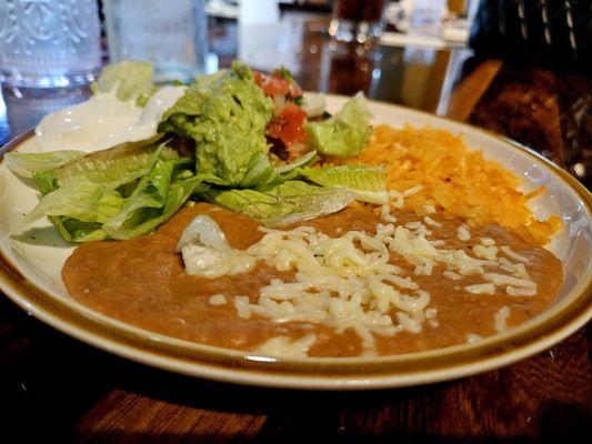 Beans, cheese, rice, lettuce, tomato, guacamole