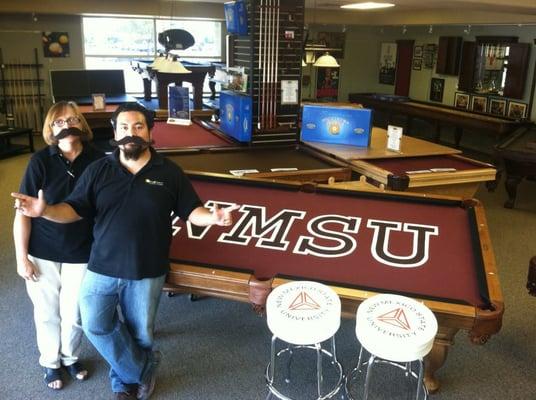 The owner, Sharon Olhausen-Chester, and former service manager, Daniel Basaldua, showing off their Aggie pride.