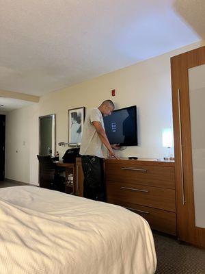 Repair man is here to get the Tv to work or the remote or something