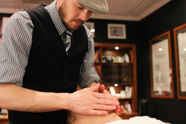 Jeramie prepares the skin for a straight shave.