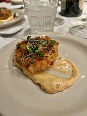 From the 2023 holiday musical show menu: Course 1 -- salmon cake with lemon caper aioli.