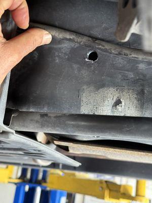 A drilled hole in the gas tank