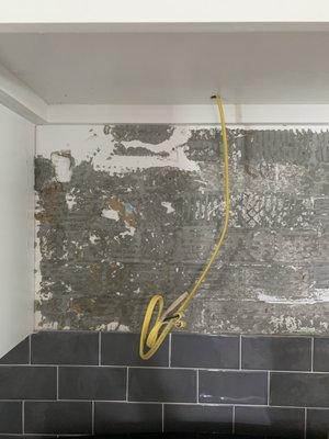 Unfinished microwave wiring and needs another row of tile ...tile is also needed along two area of splash, above the granite.