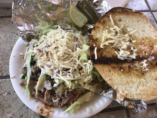 Carnitas torta with everything, lime & jalapeños on the side