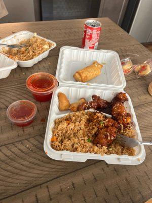 Combo #2 sesame chicken and sweet and sour chicken with fried rice and egg roll. (Partially eaten)