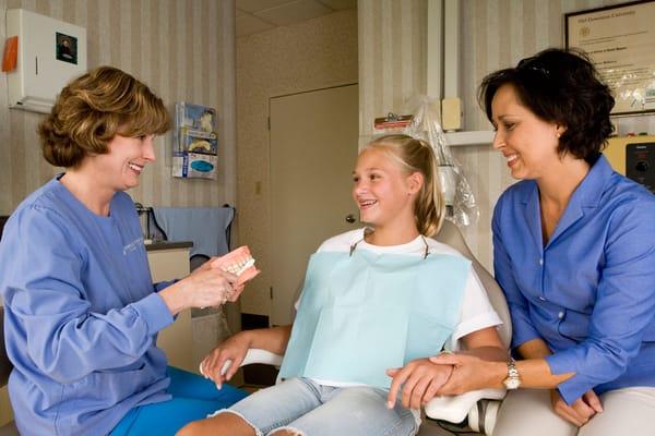 The team at Dr. Stanfield's office helping a young patient.