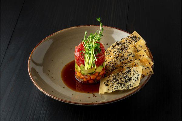 Spicy Tuna Tartare - ahi tuna, papaya, avocado, ponzu and wonton sesame chips.