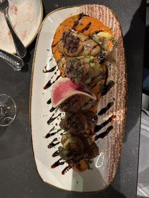 Scallops with bacon glaze on fingerling potatoes.