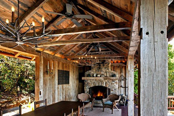 rustic hand hewn beams in an outdoor dining room by Whole Log Lumber
