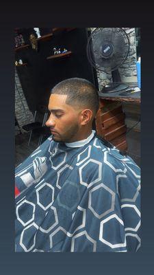 Mid taper fade with a number 3 against the grain on top w/ beard lined at the highest peak.