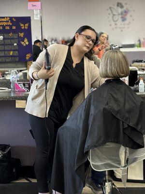 Adding finishing touches to her client.