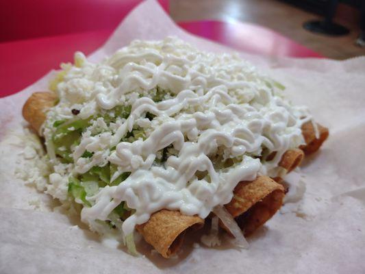 Taquitos dorados- two beef, two chicken. Lettuce, queso fresco, crema. So delicious, outstanding.
