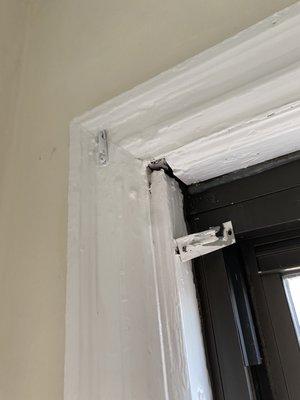 Where the curtain rod was, also a cracking window frame