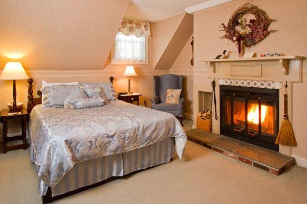 Bedroom 1 with queen bed and wood burning fireplace.