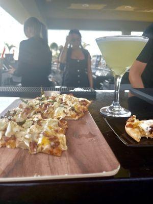 Oooey gooey chicken and cheese flatbread and a sour apple martini
