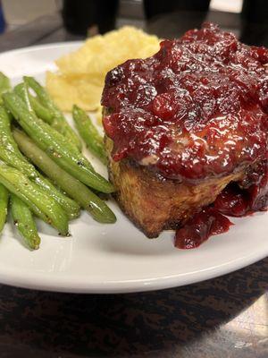 Double bone in pork chop with a cranberry reduction.